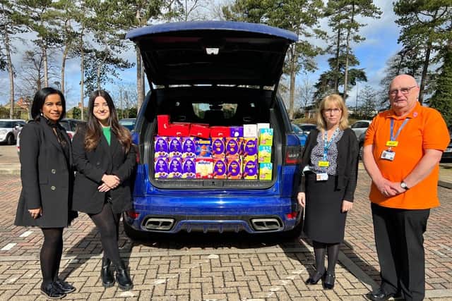 Bhangals Construction Consultants director of operations Karen Bhangal, far left, and operations manager Katie Newman, left, presenting the Easter eggs to the team at Cynthia Spencer Hospice.
