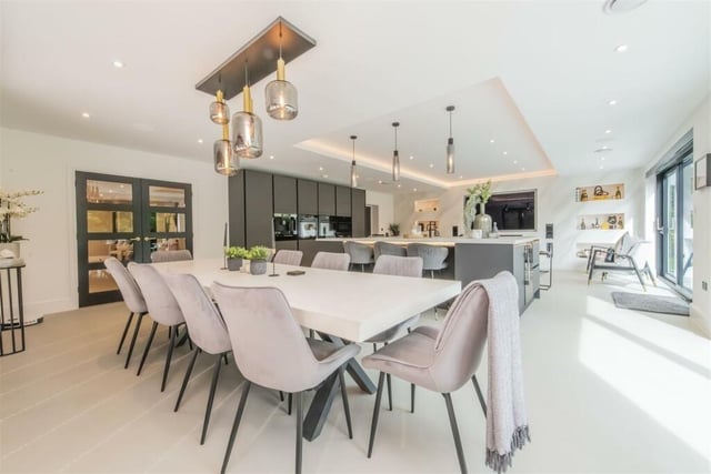 A hugely sociable kitchen diner boasts an island breakfast bar and also has a family lounge at one end