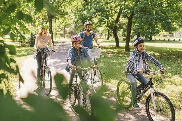 A family riding bikes in a park