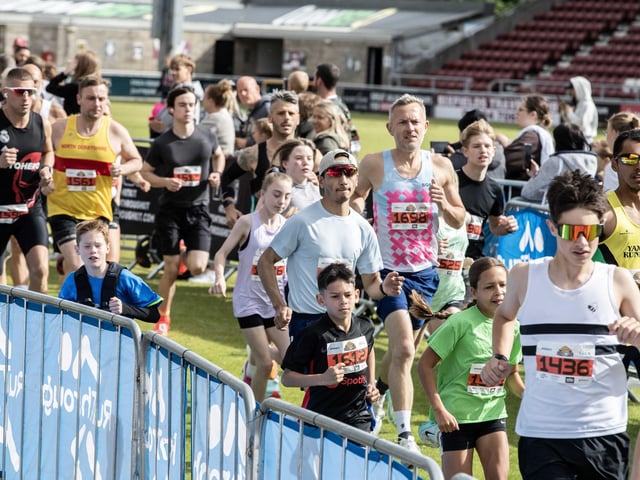 Hundreds of runners braved showers and wind to take on the race on Sunday (May 25), which started and finished at Sixfields stadium.