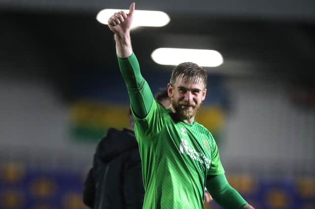 Lee Burge was all smiles after claiming his and the Cobblers' first clean sheet of the season at AFC Wimbledon on Tuesday (Picture: Pete Norton)