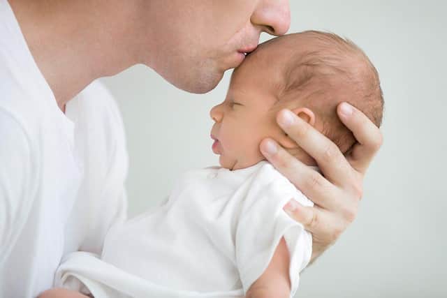 Dad kissing baby's head