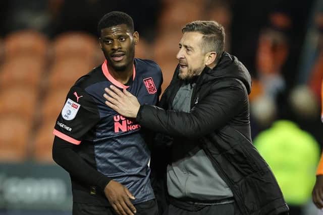 Jon Brady embraces TJ Eyoma at full-time after Saturday's draw against Blackpool