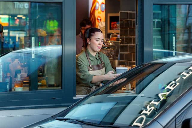 One of the first customers drives in for a coffee.