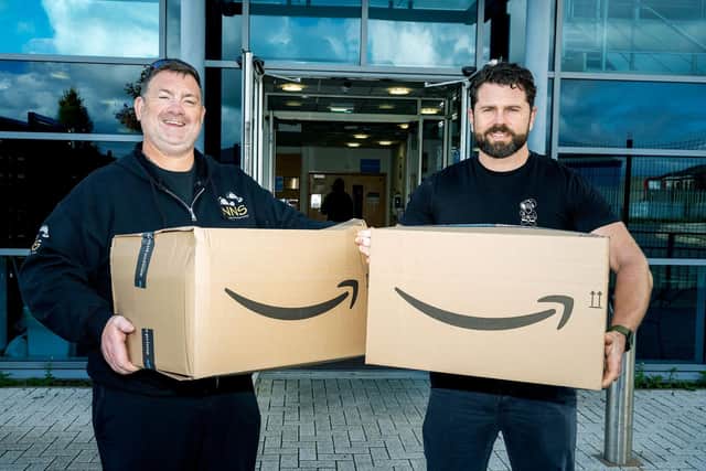 (l&r) Chris Curry with Amazon BHX3's Site Lead Josh Vause with boxes of gifts.