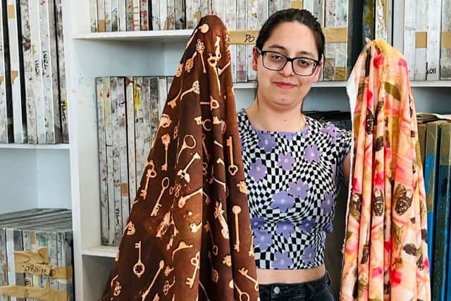 UON student, Maria Macedo holds up her final-year fashion fabrics.