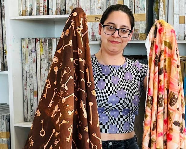 UON student, Maria Macedo holds up her final-year fashion fabrics.