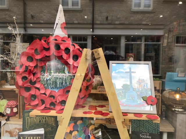 Recycled poppy wreath and a photo of the Towcester War Memorial displayed at Mooch