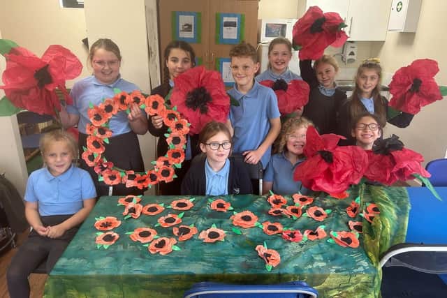 The poppies were made out of old and retired books, and the pages were hand-painted, cut and assembled by the students.