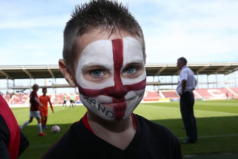 A young Northampton Town fan with a painted face looks on prior to the Sky Bet League Two match between Northampton Town and Newport County at PTS Academy Stadium on September 14, 2019.