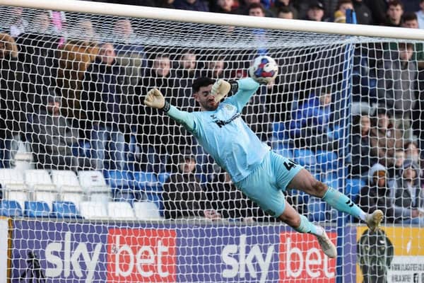 Tom King makes a flying save against Stockport on his Cobblers debut.