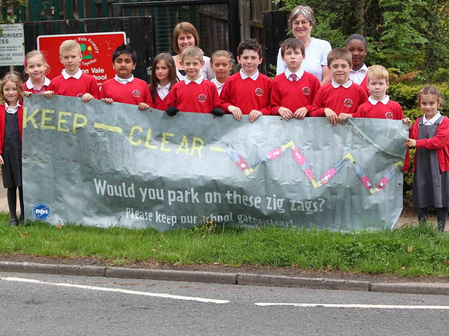 Dawn James, teacher and school council organiser and Val Sibley, Neighbourhood Watch co-ordinator with children from the school council at Abington Vale Primary School, with a giant banner to highlight road safety and parking considerately.