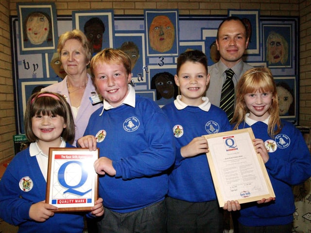 2006: Ecton Brook Primary School receive award for quality on their basic skills. Pictured with the pupils are Deputy Head Mr Smith and NCC Stephanie Beckett