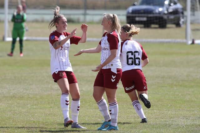 Bianca Luttman is congratulated by team-mate Eden Brown after scoring her side's first goal of the season.