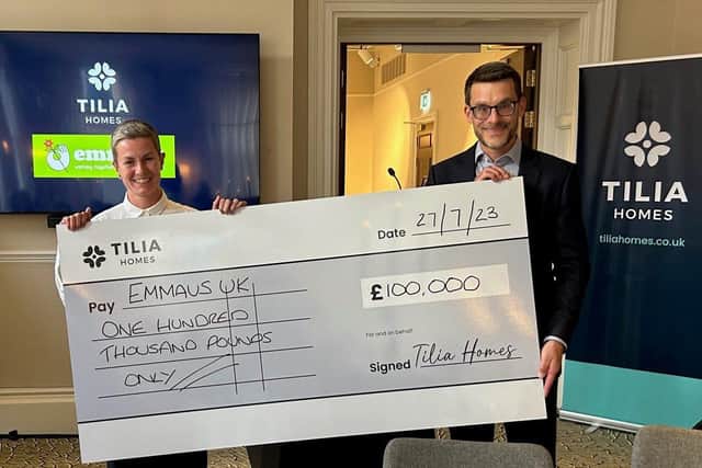 Charlotte Talott, CEO of Emmaus UK being presented with cheque by Mark Dilley, CFO of Tilia Homes