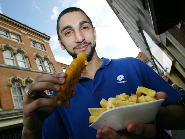 Andreas poses for a picture to go with a story on the fact that cod is now diminishing, and customers are having to seek other fish to go with their chips! Andreas worked for Fish Plus, College Street,