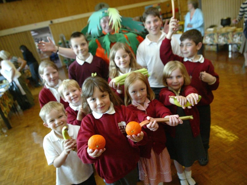 Chiltern Primary School's Food and Healthy Eating Show for children and parents. Held in the school hall - with help from staff / teachers. Photographed as a carrot is Christine Goodger with a selection of school children
