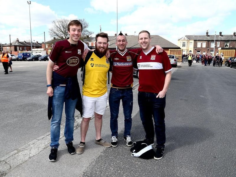 Northampton Town fans attend the game in old shirts from previous seasons during the Sky Bet League One match between Bury and Northampton Town at Gigg Lane on April 22, 2017.