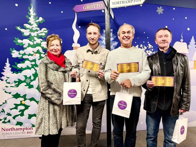 Sali Brown co-chair of Northampton BID, presents the vouchers to Tyler Comerford, Robin Taylor and John Mollett.jpg