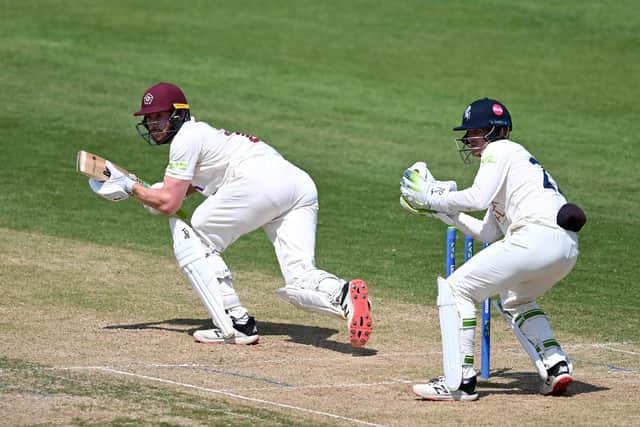 Rob Keogh plays a shot as Kent wicketkeeper Jordan Cox looks on (photo by Shaun Botterill/Getty Images)