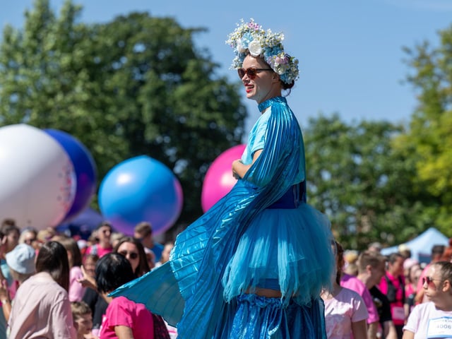 A performer on stilts helping to warm up race goers taking part in the Race For Life at Abington Park in Northampton on Sunday, July, 12, 20026. Photo by David Jackson.
