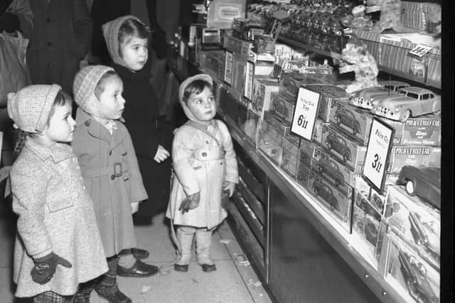 The caption does not mention which shop this is in Northampton, but it shows children shopping for a Christmas present on December 1, 1958