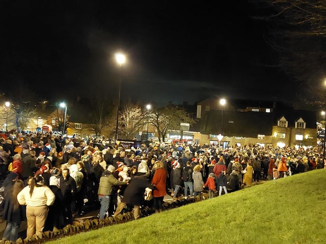 Earls Barton celebrates Christmas Eve in the Square - Crowds backed up onto the High Street