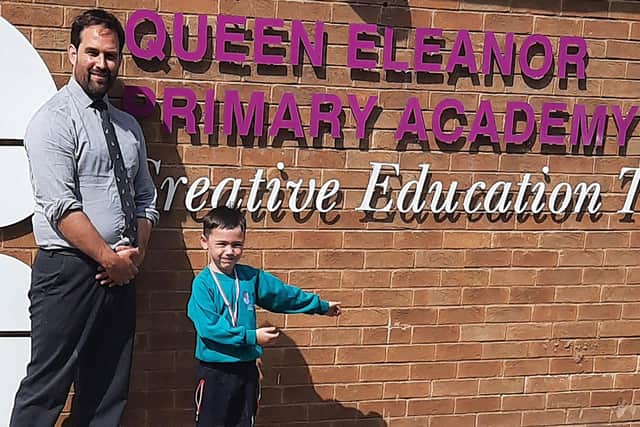 Head Teacher at Queen Eleanor Primary Academy, Isaac Howarth, with a pupil.