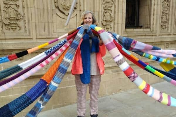 Angela McIntyre holding part of the scarf which was wrapped around the Royal Albert Hall six times
