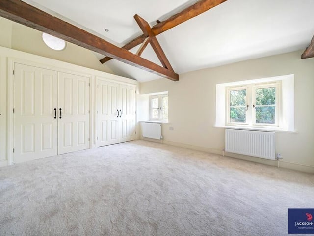 The master bedroom featured a traditional wooden beamed ceiling
