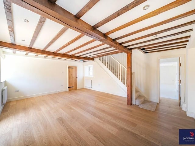 The open plan living space boasts a traditional wooden beamed ceiling