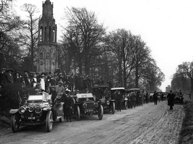 22nd April 1910: Motor cars and spectators at Queen Eleanor's Cross, Northampton, on the 10th anniversary of the 1,000 miles trial. Lord Montague is in the car on extreme left. (Photo by Topical Press Agency/Getty Images)