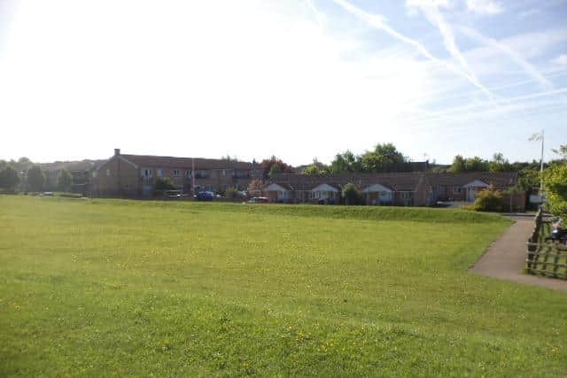 The planned skateboard park from the recreation field, facing the elderly people's homes. In the foreground is a slope and residents say the site floods