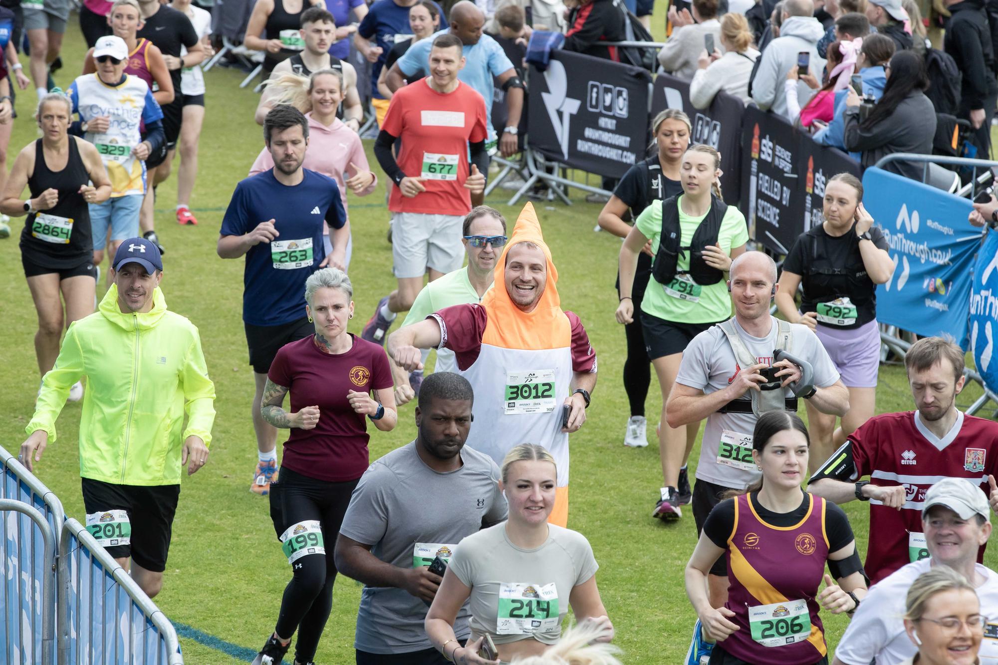 Hundreds of runners braved showers and wind to take on the race on Sunday (May 25), which started and finished at Sixfields stadium.