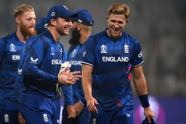 David Willey and skipper Jos Buttler were all smiles after the Northants man claimed three wickets in England's World Cup win over Pakistan on Saturday (Photo by DIBYANGSHU SARKAR/AFP via Getty Images)
