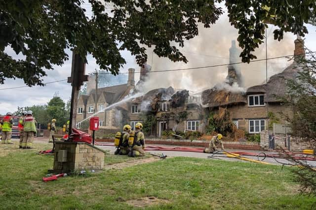 Firefighters tackle the blaze in a thatched home in Main Street, Aldwincle/ NFRS