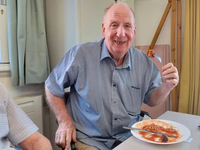 Age UK Northamptonshire's client Jim enjoying a second helping of sausage, beans and chips