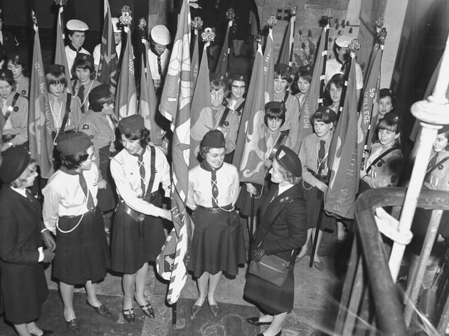 Girls uniform groups including Girl Guides with standards
