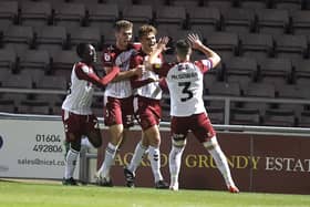 Josh Tomlinson is all smiles after heading the Cobblers into the lead against Arsenal Under-21s at Sixfields on Tuesday night (Picture: Pete Norton)