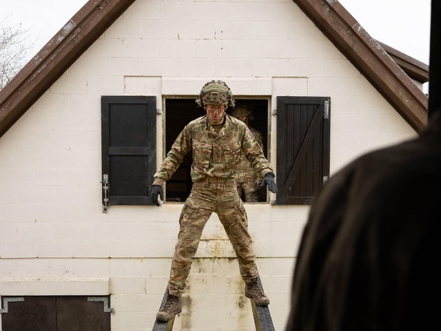 Soldiers from 2nd Battalion The Royal Anglian Regiment balances across two steel girders from house to house at height during his Confidence Course run in Copehill Down. The course was part of the regiment's build up training ahead of their deployment onto Exercise Wessex Storm.