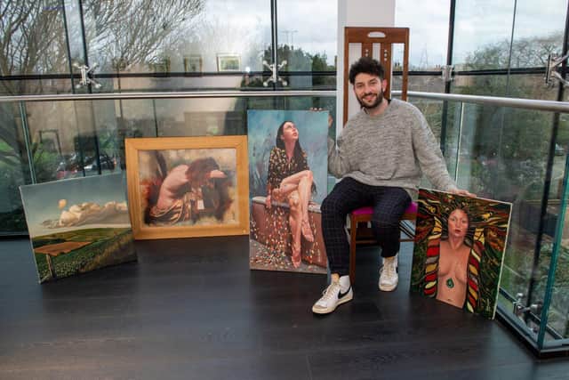 Billy Lockett pictured with some of his late father's paintings
