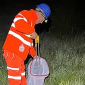 Picking up litter on the A43 roadside at night