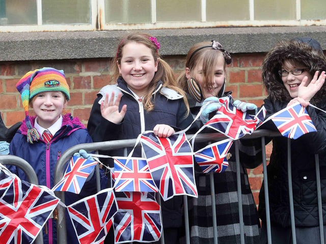 Children get ready to greet Prince Charles on his visit to Crockett and Jones shoe factory in Perry Street, Northampton, in 2013.