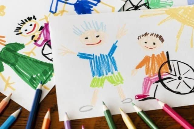 Child's drawing of child standing up and child in a wheelchair
