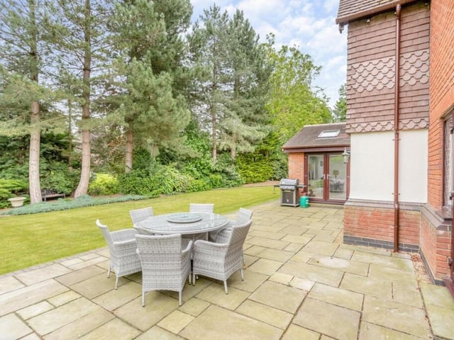 An elegant patio is the perfect spot to enjoy the property's vast garden