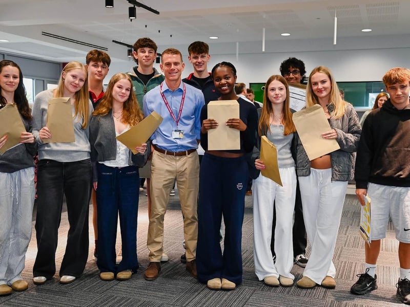 Pupils at Wellingborough School celebrate their GCSE success with new Headmaster, Simon Hawkes (Centre).