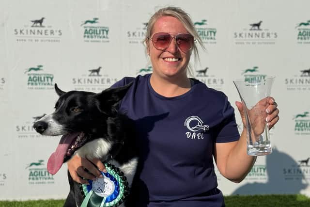 Finn with his owner and handler, Emily Bell celebrating their Second Place victory!