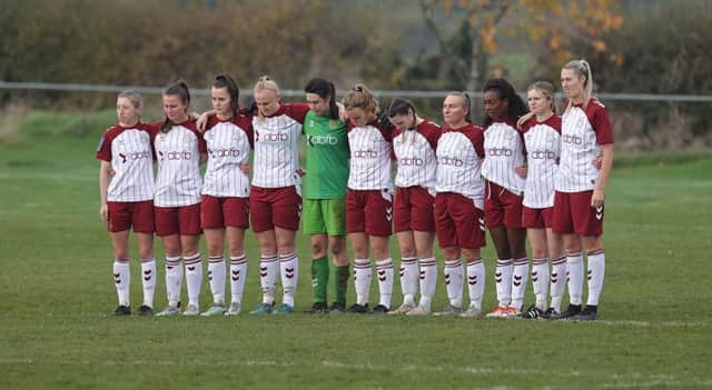 Cobblers players line up for a minute's silence for Remembrance Day before kick-off. Pictures: Pete Norton.