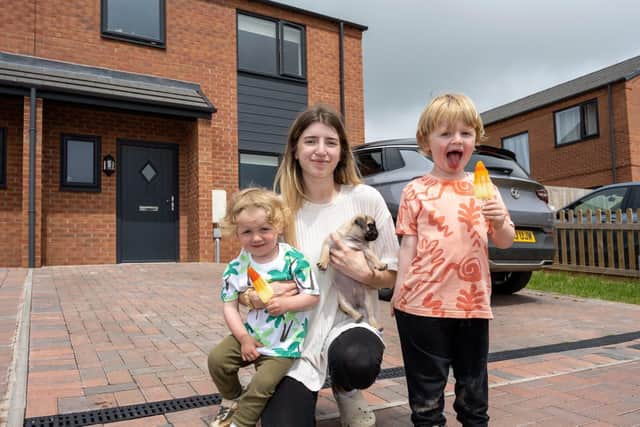 Arlo, Jasmine and Leo outside their new home in Lilbourne