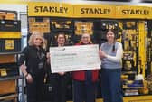 Cheque presentation to MNDA at a recent BID event hosted by Stanley, Black & Decker